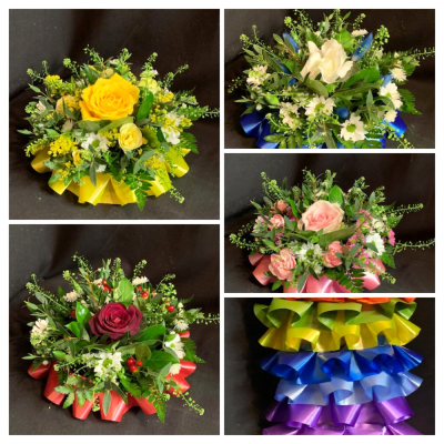 Florist Choice posy pad - A petite funeral posy (minimum 9 inches across) available in a variety of colours. State the colour you require and let our florists choose the flowers that will compliment your colour choice perfectly. Colours available, white, red, orange,green, yellow, royal blue, light blue, purple, lilac, light pink and cerise.