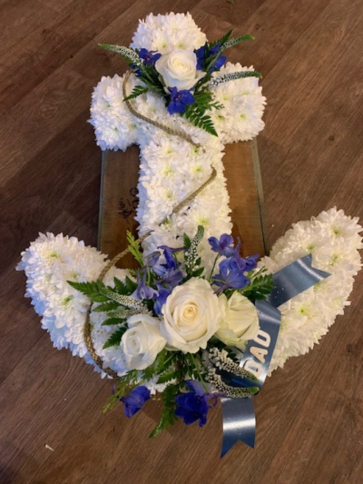 Anchor Funeral Tribute - Anchor Funeral Tribute, the perfect tribute to honour a seafaring loved one. This design has a blue ribbon edging around a white chrysanthemum based anchor shape adorned with beautiful posies of white and blue flowers connected by a luxurious gold braid. We can even add a ribbon sash with your loved ones name or title on it, if you wish, please contact us to discuss. All of our floral arrangements are made by our talented skilful florists on site. This design is available in 2ft and 3ft sizes We deliver to all funeral directors in our locality, areas covered are Gosport, Fareham, Lee-on-the-Solent , Stubbington and Titchfield  We would require 3 working days to design this tribute for you. If you have any questions or would like to speak with us then please call 023 92520123 or you can use our contact page through the website to send ua a message.