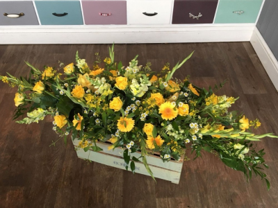 Coffin spray (shades of yellow) - Bright and beautiful arrangement in tones of summary yellow cottage style garden flowers and lovely foliage. Other colours are available for this design, please contact us with your request. Flower and foliage in the design may vary from the image that is shown. We deliver to all funeral directors in our locality including Gosport, Fareham, Lee-on-the-Solent, Stubbington, Titchfield and their surrounding areas. All our designs are made by our highly trained and skilful florists on site. Although our website is vast and varied we are aware that some customers have special requirements that we are always available to consult with in order to meet all of your floral needs. Contact details as follows, you can call us on 023 92520123, use our contact page on our website to send us a message or even come into the shop and see us face to face.