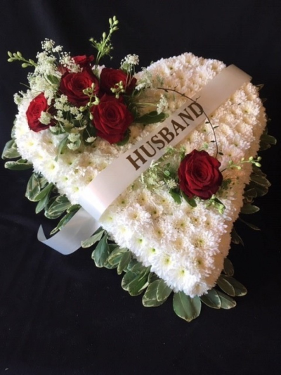 Red rose funeral heart - Red rose heart design with a foliage edge also ribbon sash with name/relation lettering of your choice. This design can be made with different colour posies, please contact us to discuss or if you are ordering online then please write in the (Special Request) box what colour you would like and the name/relation for the lettering. Flower and design may vary. All of our floral design are made by our highly trained skilful florists on site. We deliver to all funeral directors in our locality including Gosport, Fareham, Lee-on-the-Solent, Stubbington, Titchfield and their surrounding areas. Although our website is vast and varied we are also aware that some customers may have special requirements that we are always available to consult in order to meet all of your floral needs. Our contact details are as follows. You can use our contact page to send us a message, call us on 023 92520123 or even come into the shop and see us face to face.