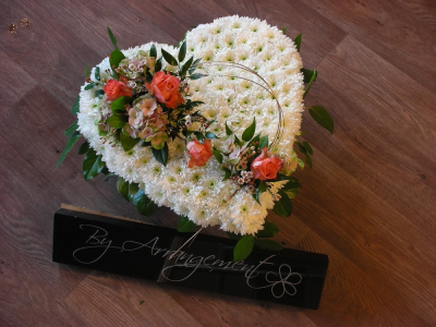 Heart Autumnal colours for Funeral - A beautiful based Heart design in warm autumnal colours, consisting of a chrysathemum base and mixed flower posies. The flower and foliage flower may vary from image shown. This design can be made using a different colour for the posies, please contact us to discuss. All of our floral designs are made by our highly trained skilful florists on site. We deliver to all funeral directors in our locality including Gosport, Fareham, Lee-on-the-Solent, Stubbington, Titchfield and their surrounding areas. Although our website is vast and varied we are also aware that some customers may have special requirements that we are always available to consult in order to meet all of your floral needs. Our contact details are as follows. You can call us on 023 92520123, use our contact page through our website to send us a message or even come into the hsop and see us face to face.