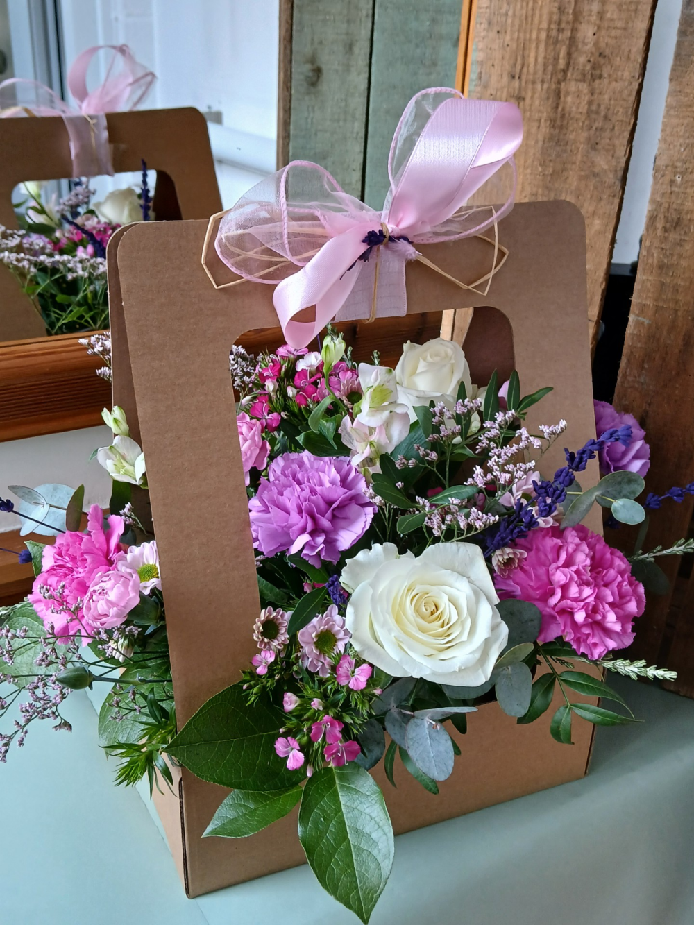 Delightful Gift bag Flower Arrangement in Pinks and purple