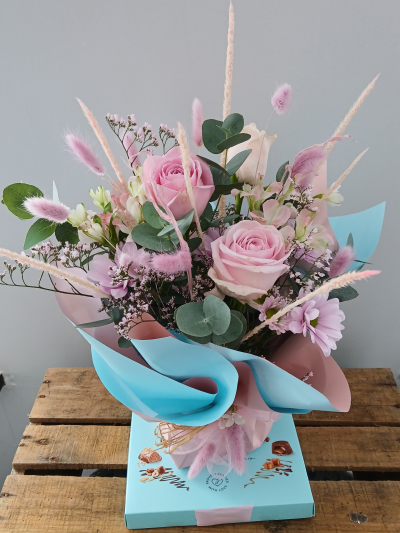 Pink blue flower posy and chocolates - A perfect gift for any occasion. A sweet posy in tones of pink flowers, arranged and presented in a pink and blue wrap, finished with a pretty bow and delivered with chocolates. Design may vary from the image shown. 

By Arrangement deliver to all areas in our locality, including Gosport, Fareham, Lee-on-Solent, Stubbington, Titchfield and their surrounding areas. We offer a same day delivery on all orders placed before 2pm.  All of our designs are made by our highly trained skilful florist on site. On our website you can find flower arrangements for every occasion. Although our website is vast and varied we aware that some customers have special requirements that we are always available to consult in order to meet all your floral needs. Contact details as follows, you can call us on 023 92520123, use our contact page to send us a message. Local florist in Gosport, flowers for all occasions.