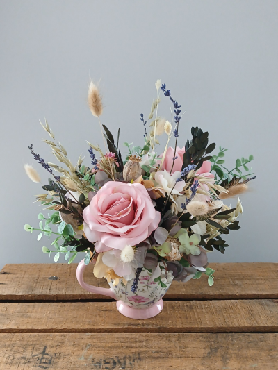 Artificial Cup Arrangement - A sweet cup design in artificial flowers and dried grasses. Please note that the arrangement and cup may vary from the image shown.

By Arrangement deliver to all areas in our locality, including Gosport, Fareham, Lee-on-Solent, Stubbington, Titchfield and their surrounding areas. We offer a same day delivery on all orders placed before 2pm.  All of our designs are made by our highly trained skilful florist on site. On our website you can find flower arrangements for every occasion. Although our website is vast and varied we aware that some customers have special requirements that we are always available to consult in order to meet all your floral needs. Contact details as follows, you can call us on 023 92520123, use our contact page to send us a message. Local florist in Gosport, flowers for all occasions.